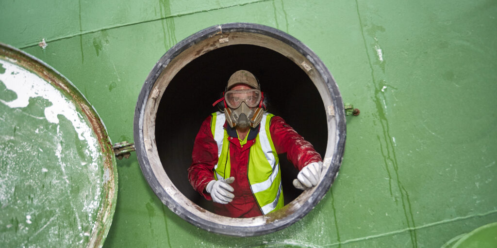 An employee in a confined space. Following low risk confined spaces training.