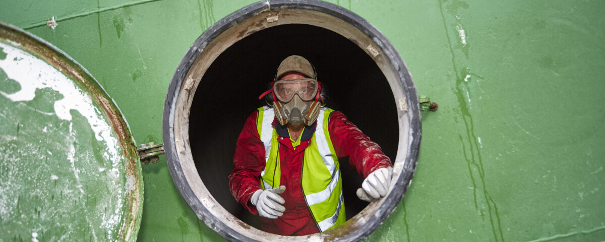 An employee in a confined space. Following low risk confined spaces training.
