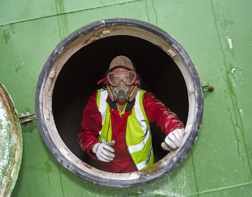 An employee in a confined space. Following low risk confined spaces training.
