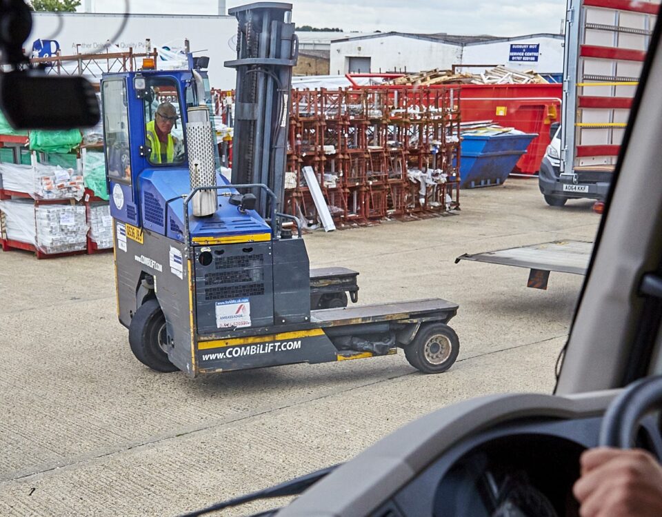 A employee in a yard directing traffic following Lorry Banksman Training Course