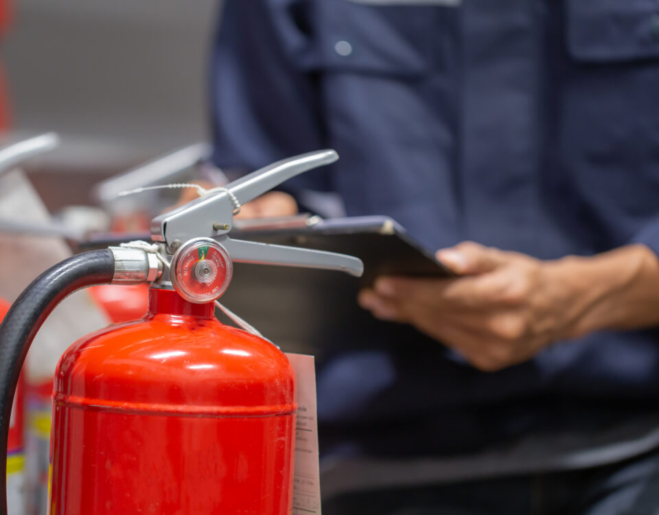 A man checking fire extinguisher after Fire Marshal Training Course