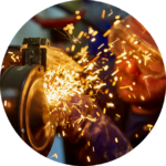An employee using an abrasive wheels with protective PPE, following abrasive wheels training.