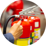 A employee checking a fire extinguisher for Fire Risk Assessment
