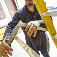 A man working at height using a ladder following a steps and ladders training