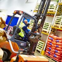 Counterbalance Truck A employee using a counterbalance forklift truck in a warehouse after for forklift truck training