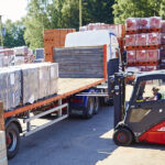 A employee using a counterbalance forklift truck to load a lorry in at a company in Norfolk