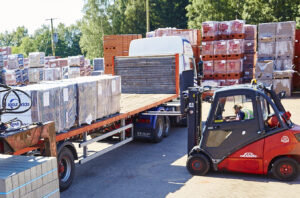 A employee using a counterbalance forklift truck to load a lorry in at a company in Norfolk