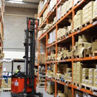 Reach Truck Training An employee using a reach forklift truck in a warehouse in a company in Norfolk