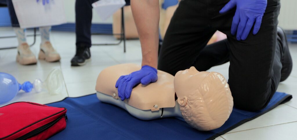 NUCO first aid trainer demonstrating to an delegate on a First Aid at Work course.