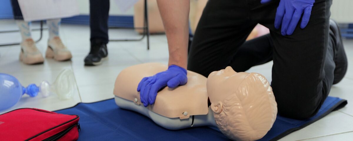 NUCO first aid trainer demonstrating to an delegate on a First Aid at Work course.