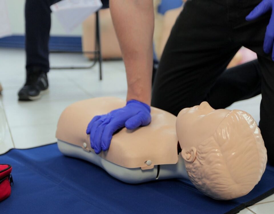 NUCO first aid trainer demonstrating to an delegate on a First Aid at Work course.