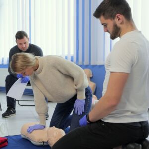 NUCO first aid trainer demonstrating to an delegate on a First Aid at Work course.