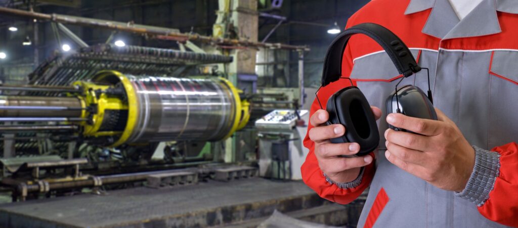 An employee using ear protection following a noise assessment