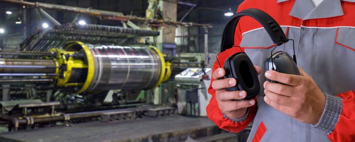 An employee using ear protection following a noise assessment
