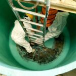 Workers in a confined space. Following low risk confined spaces training.