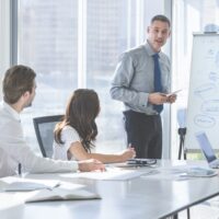 A Trainer running IOSH training course for delegates at a company