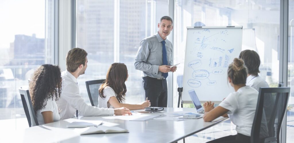A Trainer running IOSH training course for delegates at a company