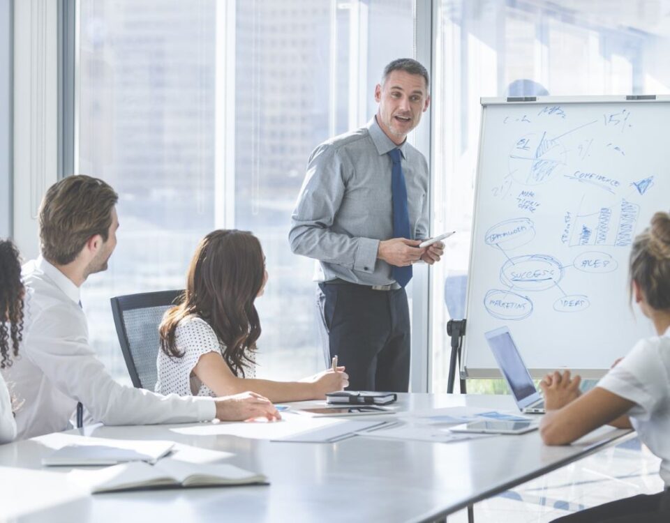 A Trainer running IOSH training course for delegates at a company