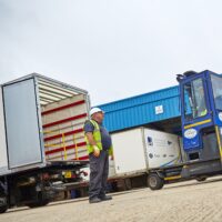 A employee in a yard directing traffic following Lorry Banksman Training