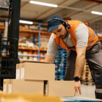 Manual Handling Training A employee moving boxes from a forklift following manual handling training