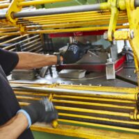 An employee using a Power Press following the training course in Norfolk