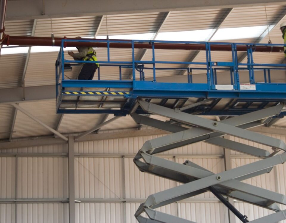 Scissor lift in a warehouse being used for maintenance