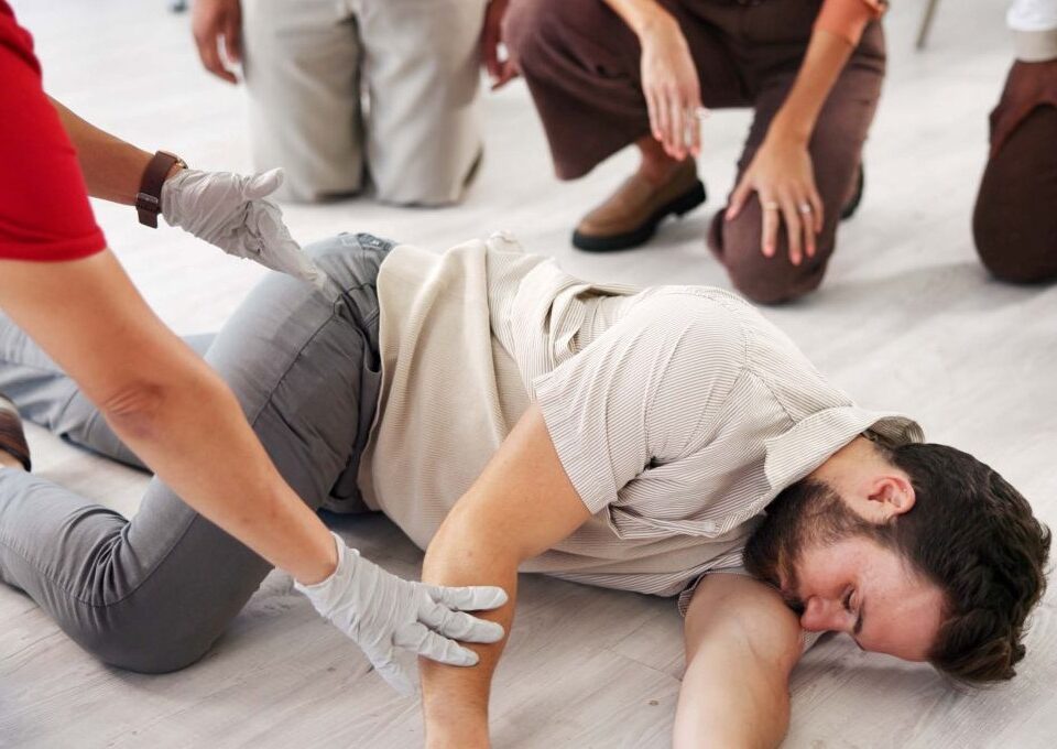 trainer demonstrating the recovery position