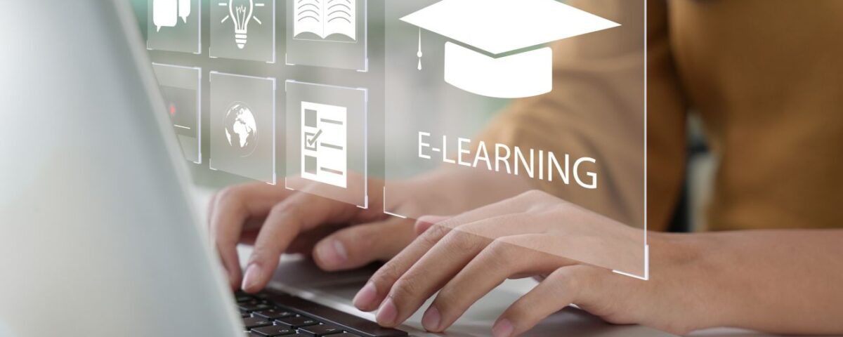 Person typing on a laptop with e-learning icons displayed on the screen.
