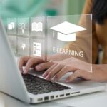 Person typing on a laptop with e-learning icons displayed on the screen.